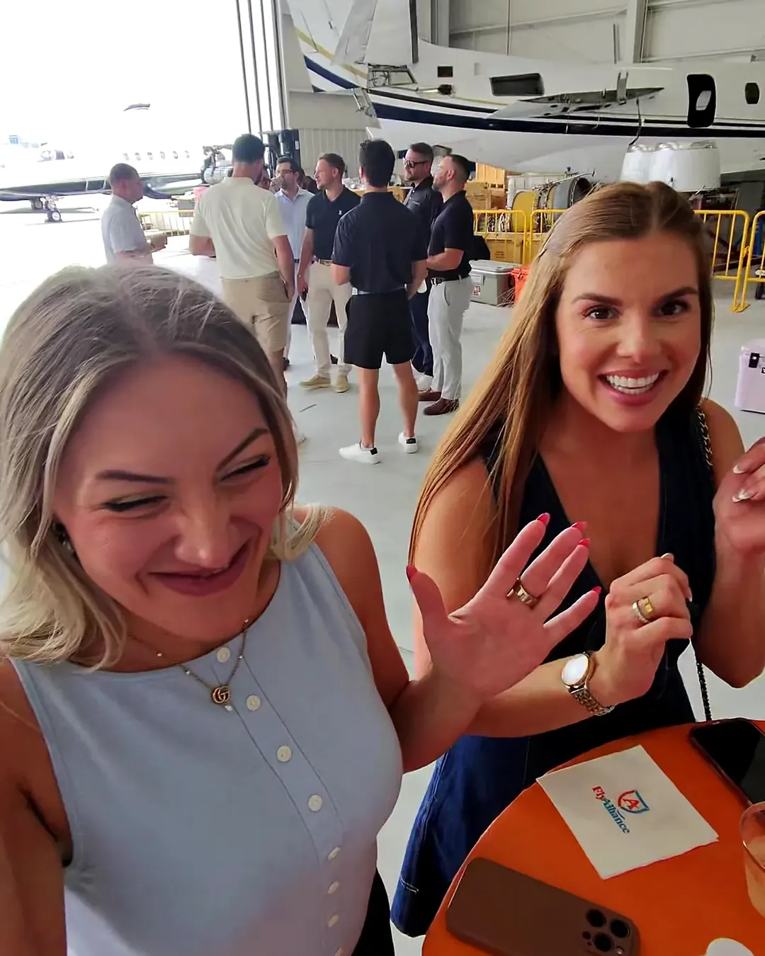Two guests laughing at a corporate event after a card trick