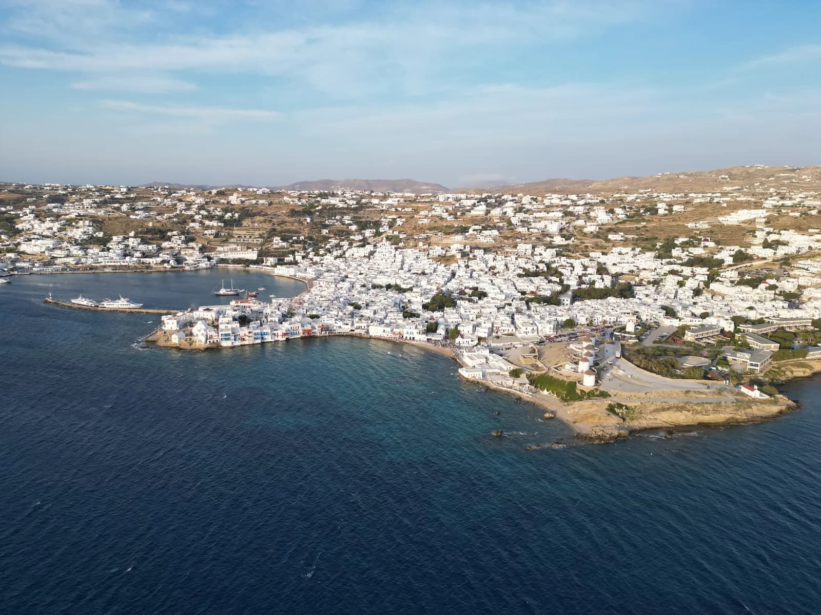 Aerial view of the white town of Mykonos, with Little Venice and the windmills by the water